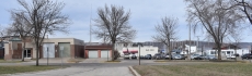 City-owned property on South High Street in Lake City. The building at the far left was the public safety building until a new facility was completed in 2017. At right is a public parking lot. Behind the city land is property owned by a developer who recently sought a demolition permit for several buildings.